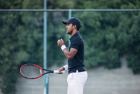Side view of a tennis player looking after a serve