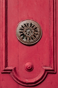 Bronze metal decoration on a red