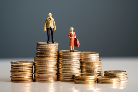Miniature people on coins stack