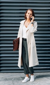 Stylish middle aged woman wearing a coat talking on a mobile phone