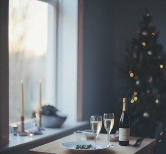 Champagne glasses with food and christmas tree in living room  i