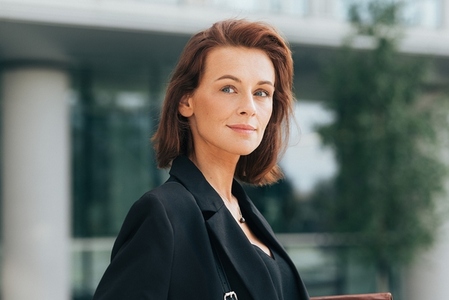 Portrait of a middle aged businesswoman with ginger hair looking away