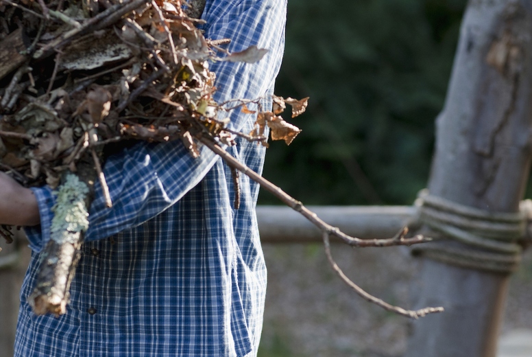 Young man carrying firewood