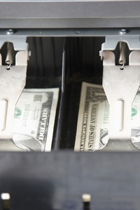 Close up of an open cash register drawer with american dollars