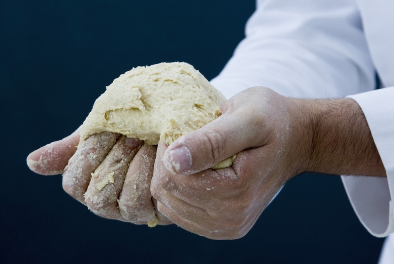 Close up of a chef hands kneading pizza dough