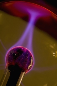 Plasma ball with red purple and pink electrical discharge