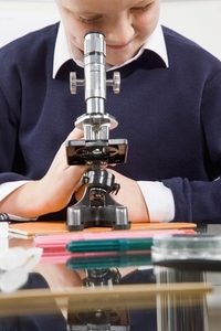Schoolboy looking in a microscope