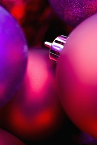 Extreme close up of red and purple Christmas baubles
