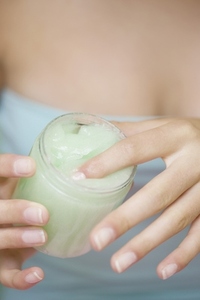 Close up of a woman hands holding a  cream jar