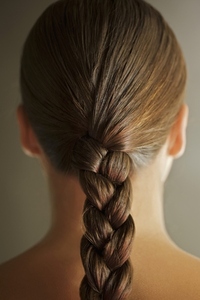 Back view of young woman head with one braid