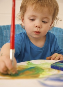 Young boy painting with watercolors