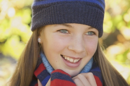 Smiling young girl wearing a woolly hat