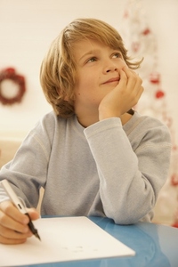 Boy writing a letter to Father Christmas