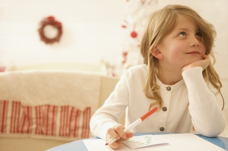 Girl writing a letter to Father Christmas