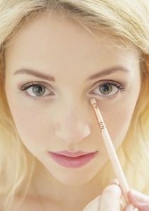 Close up of Young Woman Applying Eye Shadow