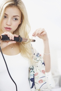 Young Woman Using Curling Iron