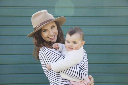 Smiling Woman Holding Baby Girl