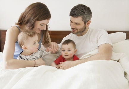 Couple in Bed with Baby Twins