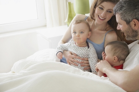 Couple in Bed with Baby Twins