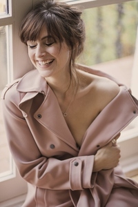 Portrait of Woman Wearing Pink Overcoat Smiling