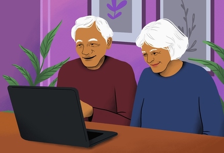 Smiling retired senior couple video chatting at laptop from home