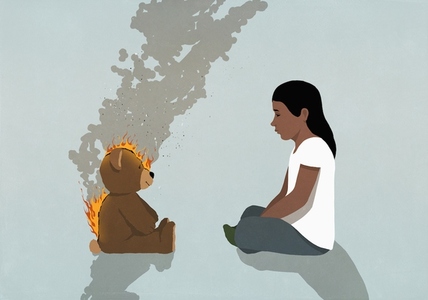 Girl watching teddy bear on fire burning