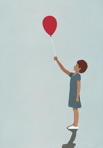 Girl holding red balloon on blue background
