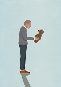 Senior man holding and looking at teddy bear on blue background