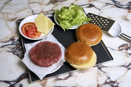 Still life hamburger ingredients on tray