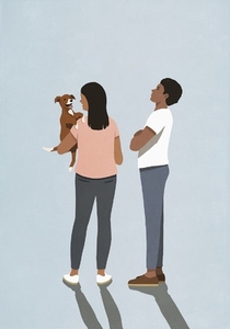 Jealous man watching girlfriend holding cute puppy dog