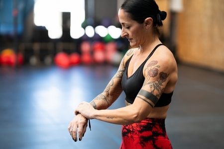 Woman wrapping her wrist to prevent injury on a gym