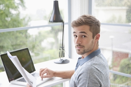 Man Sitting at Desk in Home Office