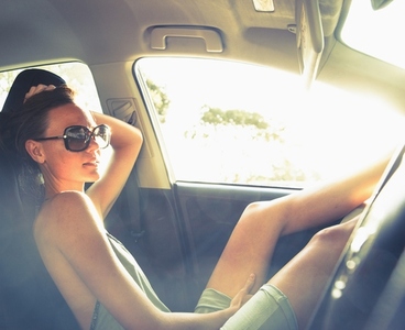 Woman Reclining in Car with Legs Raised