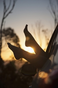 Woman039 s Feet Sticking out of Car Window at Sunset