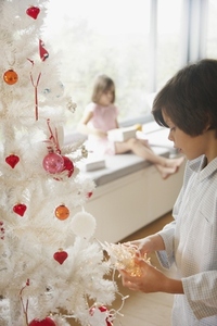 Young Boy Decorating Christmas Tree