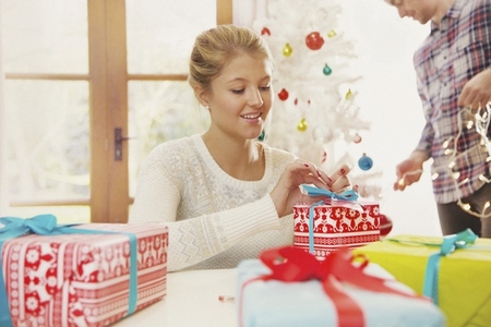 Young Woman Wrapping Christmas Present