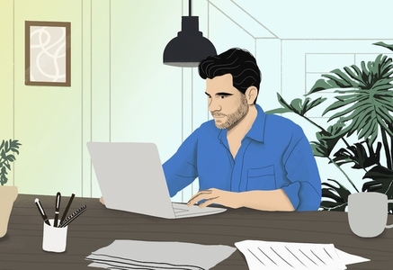 Man working from home at laptop in dining room
