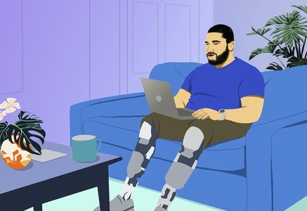 Man with prosthetic legs working from home at laptop on living room sofa