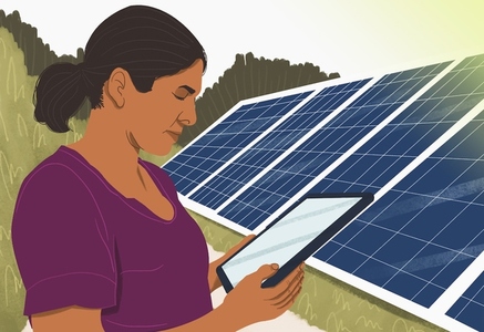Woman with digital tablet standing next to solar panels