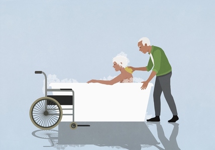 Caring senior husband helping disabled wife bathing in bubble bath