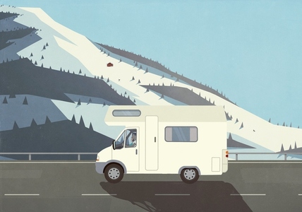 Man on vacation driving RV along remote  snowy mountains