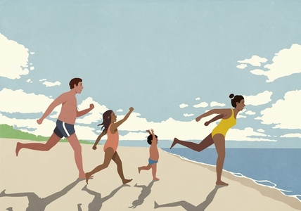 Happy excited family on vacation running toward ocean on sunny summer beach