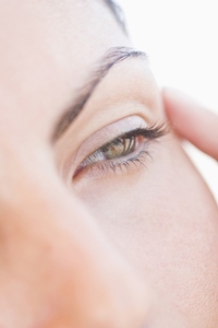 Extreme Close up of Woman Touching Corner of her Eye