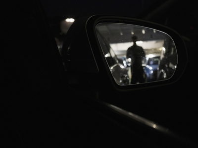 Side View Mirror Reflecting Silhouette aboard Ferry