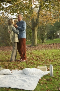 Senior couple dancing in a park