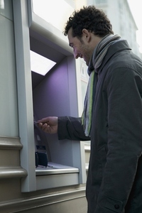 Man in coat at ATM