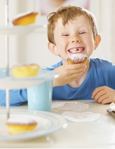 Young boy eating a cupcake