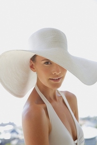 Close up of a young woman wearing a white hat