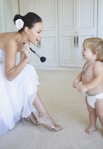 Bride Laughing and Playing with Baby Boy