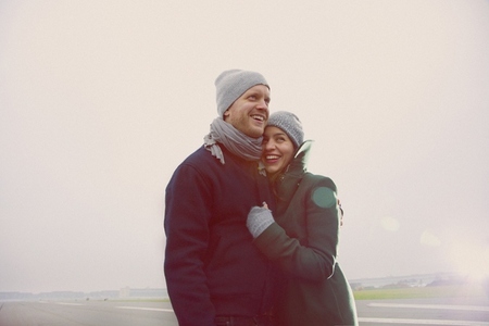 Smiling Couple Embracing  on Airport Runway
